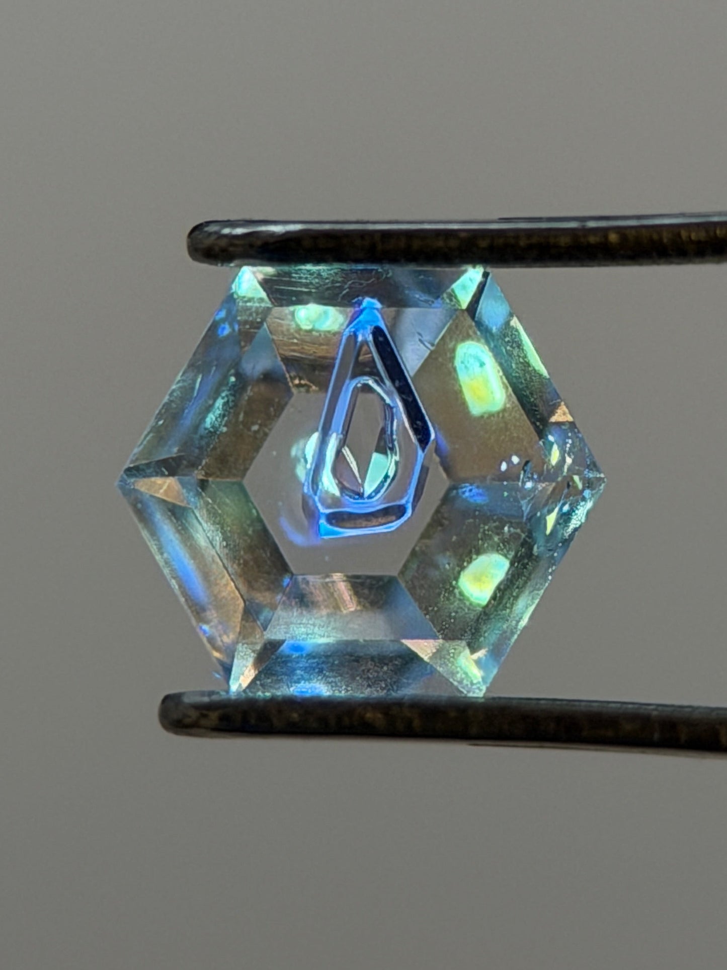 0.31 ct Hexagon Petroleum Quartz with Dual Inclusions – Deep Blue & Golden Fluorescent Negative Crystals – Madagascar