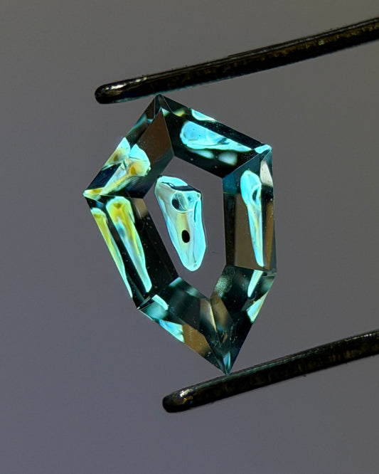 0.32 ct Shield Cut Petroleum Quartz with Moving Bubble Enhydro – Madagascar (4.3 x 6.7 mm)